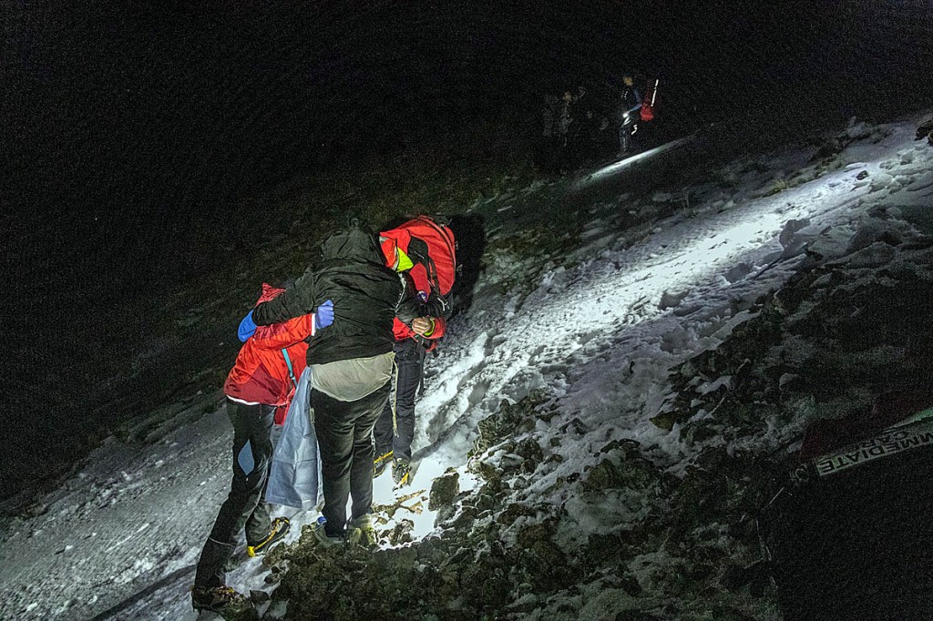 Keswick team members support one of the group during the incident. Photo: Keswick MRT