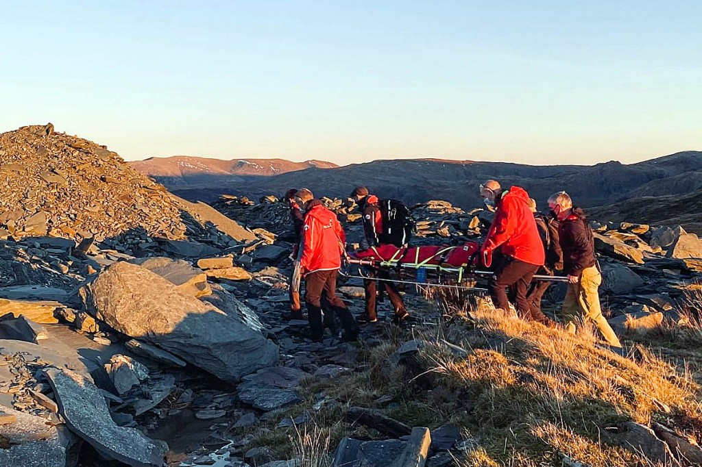 Rescuers stretcher the walker from the fell. Photo: Keswick MRT Rescuers stretcher the walker from the fell. Photo: Keswick MRT
