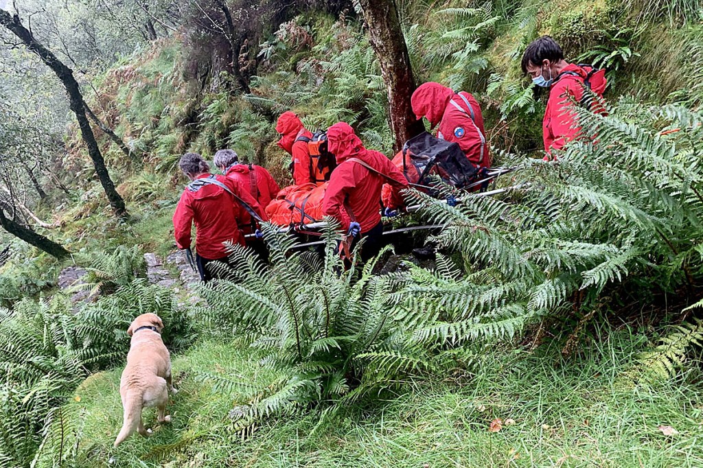 Team members stretcher the injured walker from King's How. Photo: Keswick MRT