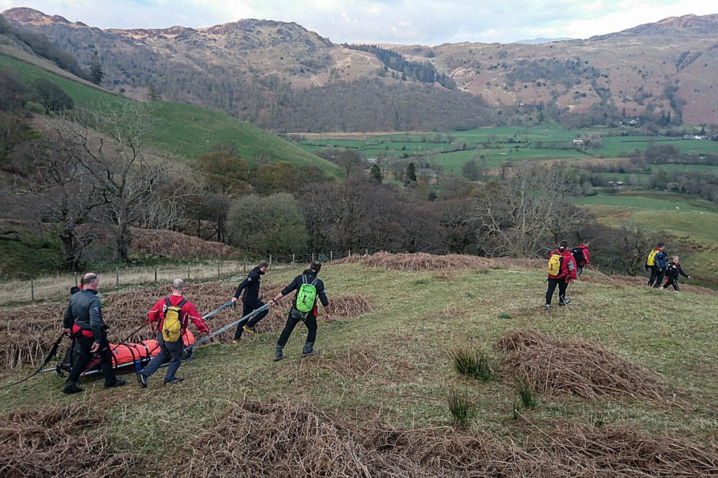 Rescuers stretcher the youth from the fell. Photo: Keswick MRT Rescuers stretcher the youth from the fell. Photo: Keswick MRT