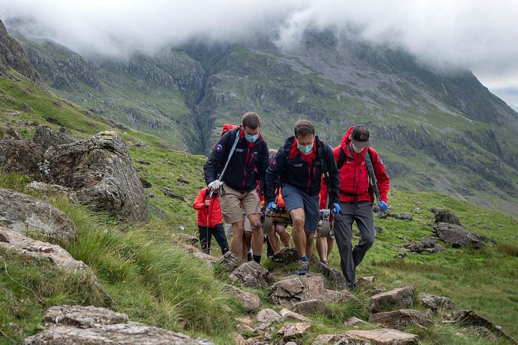 Rescuers stretcher the injured walker down the Corridor Route. Photo: Keswick MRT Rescuers stretcher the injured walker down the Corridor Route. Photo: Keswick MRT