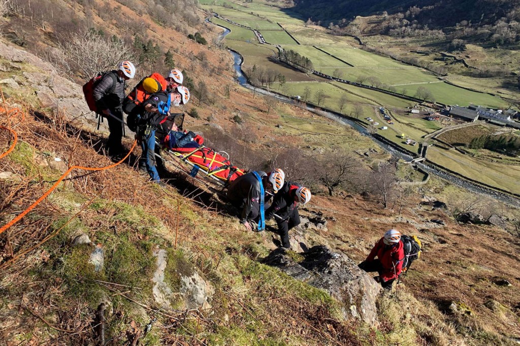 The team manoeuvres the stretcher down the steep path at Sourmilk Gill. Photo: Keswick MRT