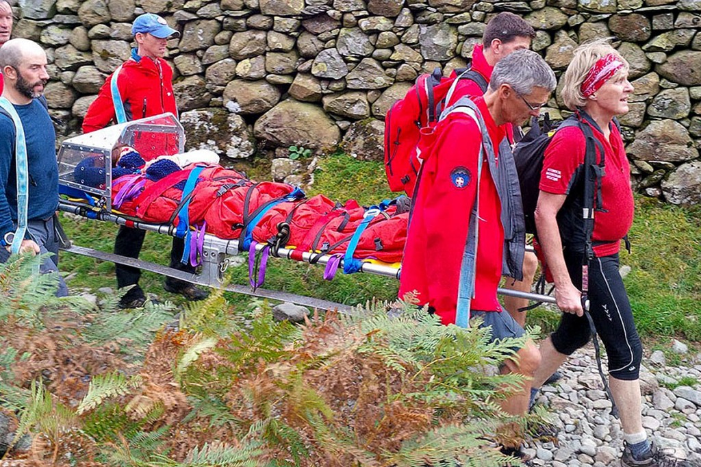 Team members stretcher one of the walkers from the fell. Photo: Keswick MRT Team members stretcher one of the walkers from the fell. Photo: Keswick MRT