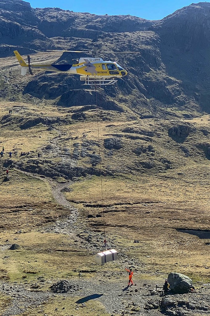A helicopter lifts the stretcher box into position. Photo: Keswick MRT