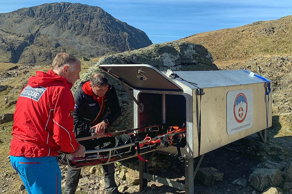 Team members place a stretcher in the new box. Photo: Keswick MRT