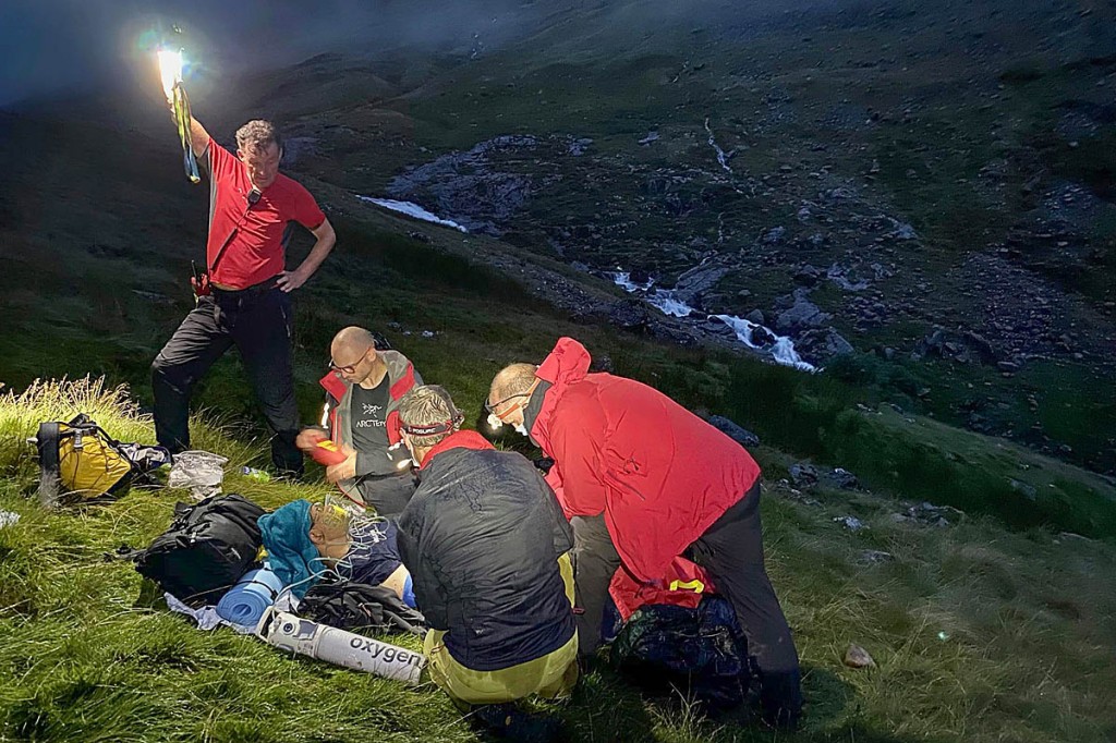 Team members tend to the injured walker near Styhead Tarn. Photo: Keswick MRT Team members tend to the injured walker near Styhead Tarn. Photo: Keswick MRT