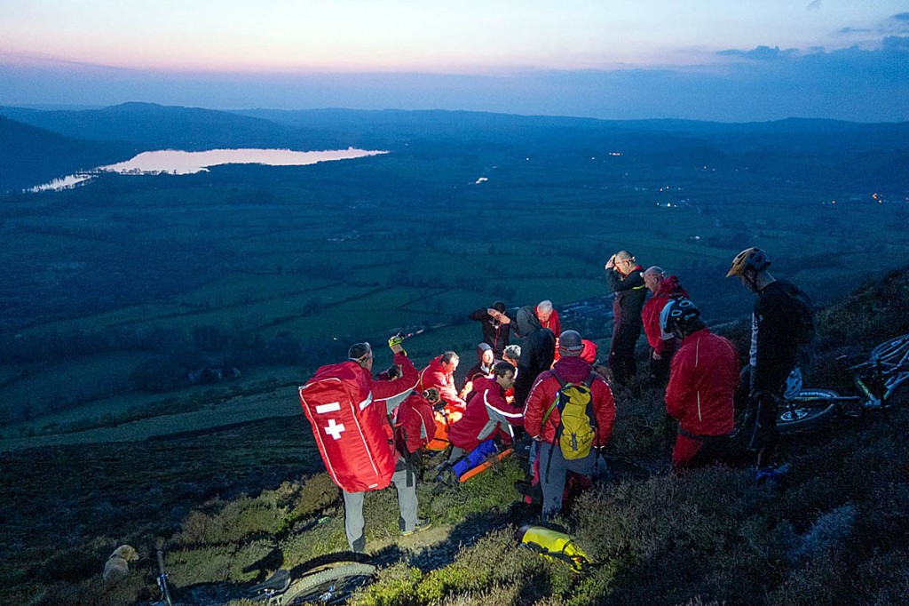 Team members tend to the injured mountain biker on Ullock Pike. Photo: Keswick MRT Team members tend to the injured mountain biker on Ullock Pike. Photo: Keswick MRT