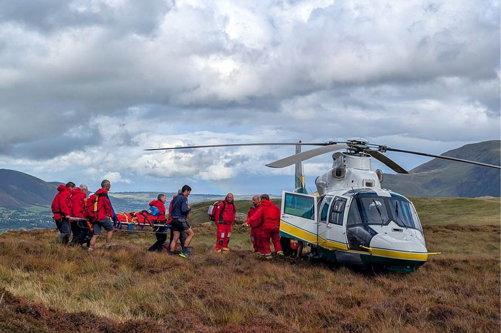 Keswick MRT members stretcher the walker to the Great North Air Ambulance. Photo: Keswick MRT