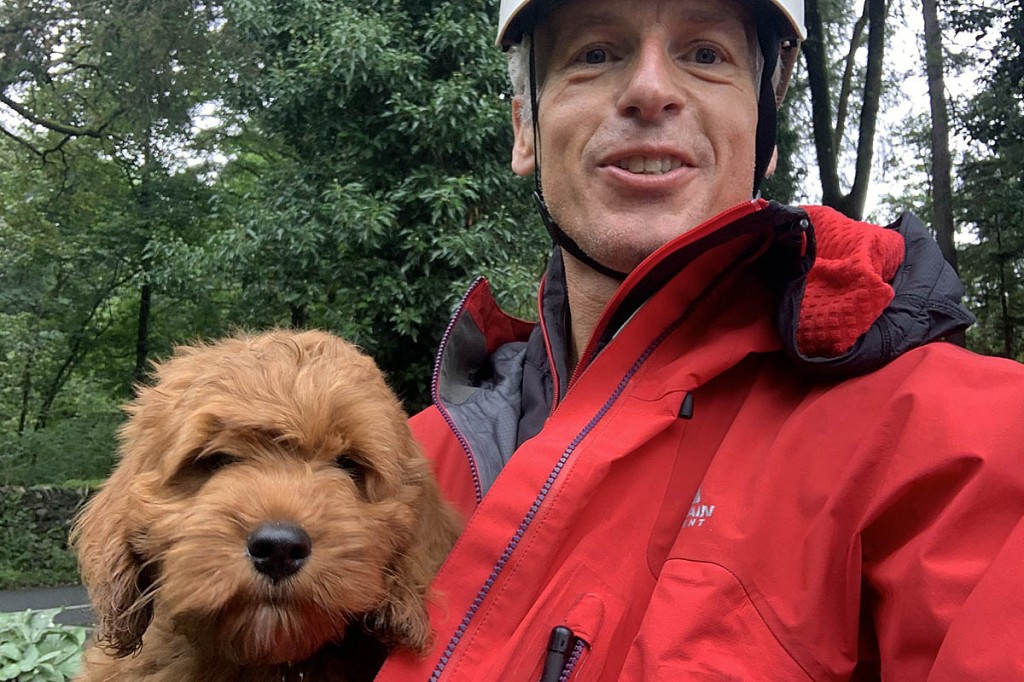 Brody safe with a team member after his adventure. Photo: Keswick MRT