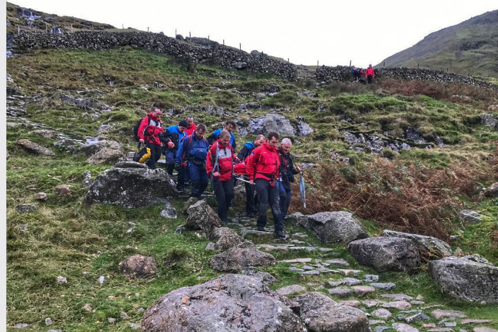 Rescuers stretcher the man down the Sty Head path. Photo: Keswick MRT