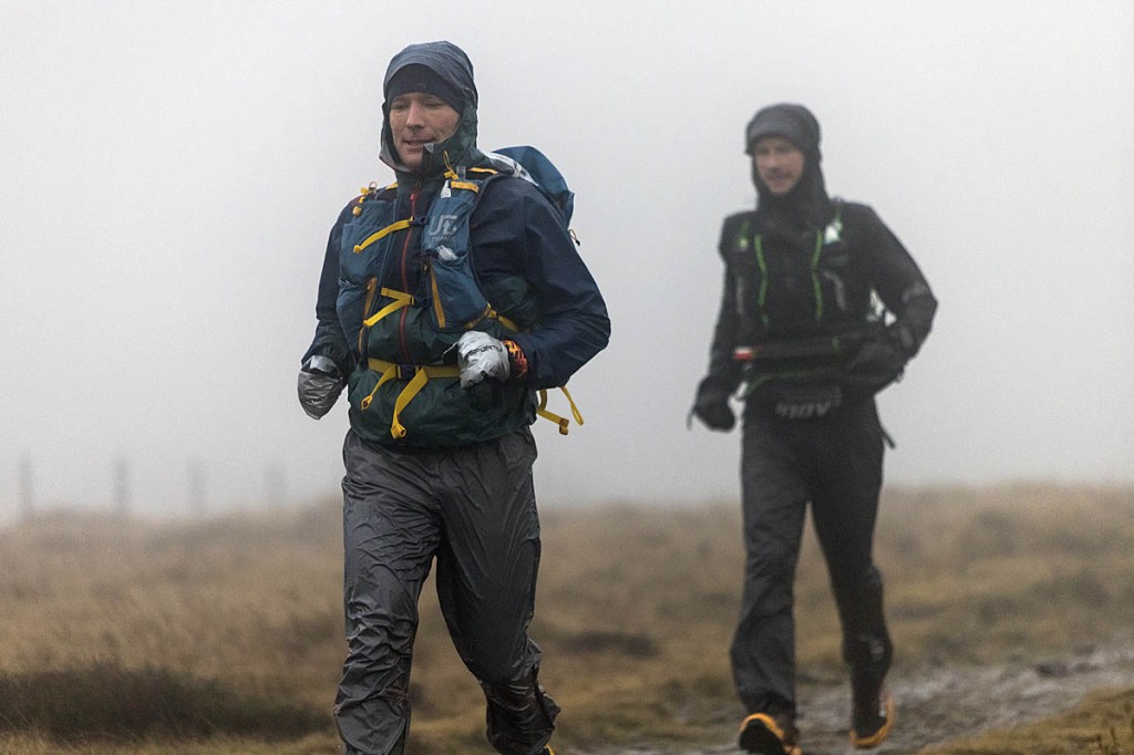 Kim Collison leads Damian Hall across White Hill in the South Pennines gloom. Photo: Bob Smith/grough