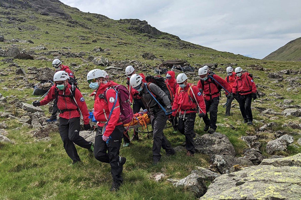 Wasdale Mountain Rescue Teams in PPE during a stretcher carry on a hot, humid day Wasdale Mountain Rescue Teams in PPE during a stretcher carry on a hot, humid day