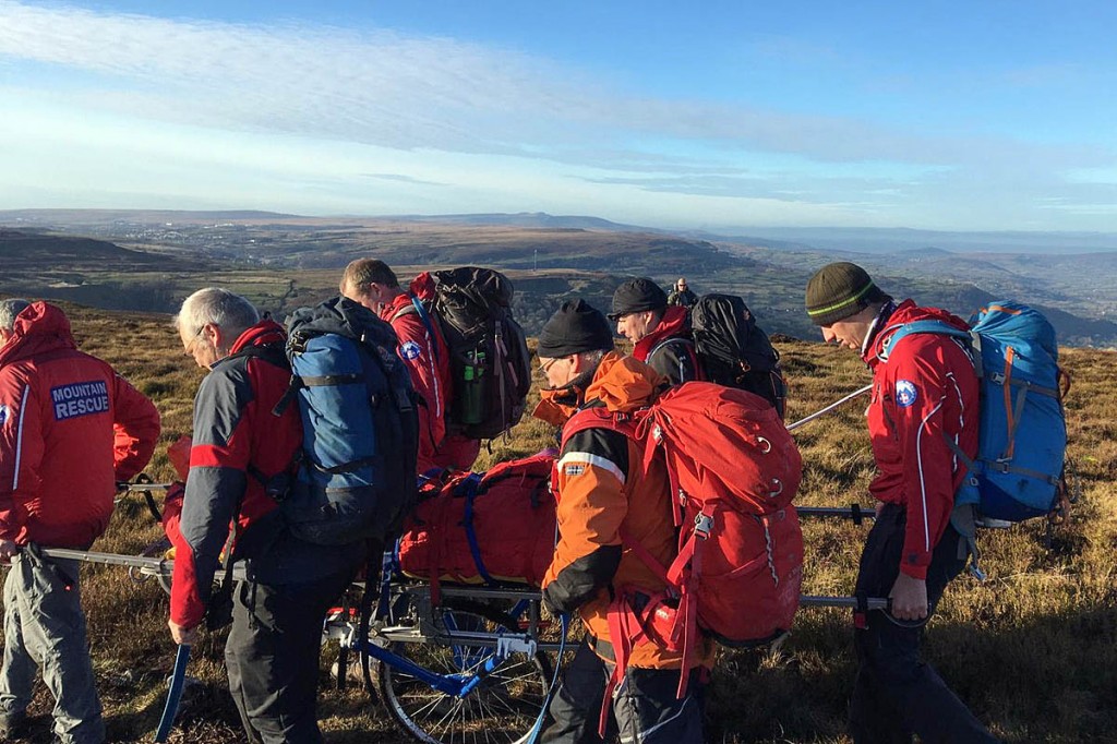 Rescuers stretcher the injured walker from the hill. Photo: Longtown MRT