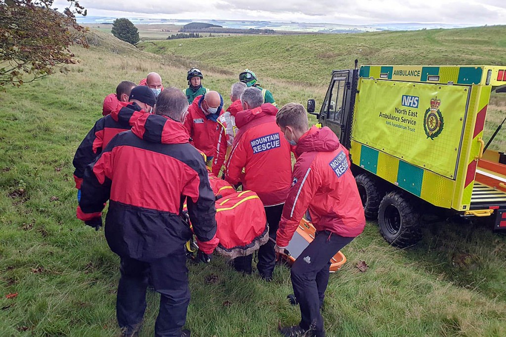 Rescuers stretcher the injured walker to the ambulance service's all-terrain vehicle. Photo: NNPMRT