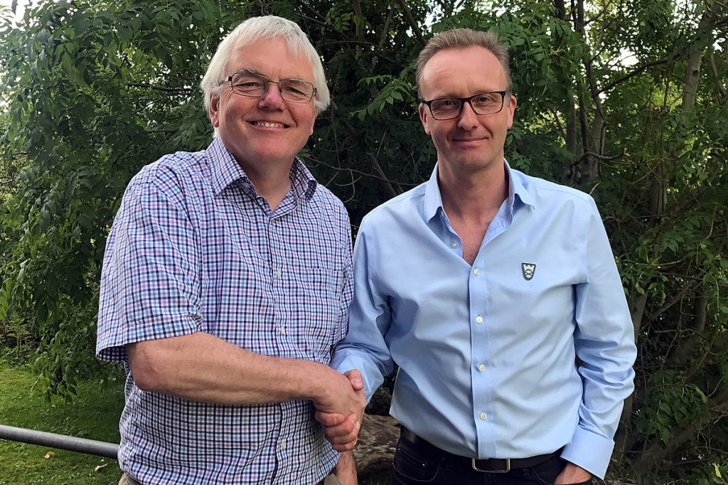 Dave Shand, left, of Hilltrek, and Mark Bishop of NTS shake hands on the agreement
