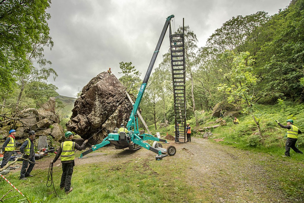 Workers lift the new ladder into place. Photo: John Malley