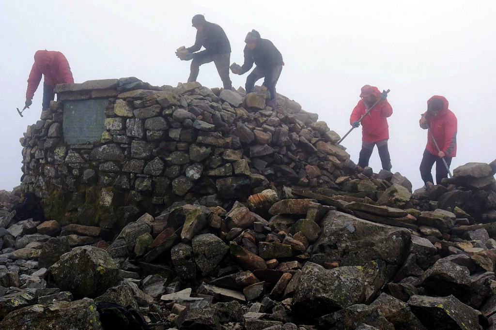 Rangers work on restoring the summit cairn. Photo: Paul Kinston/NNP Rangers work on restoring the summit cairn. Photo: Paul Kinston/NNP