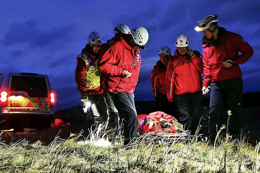 Rescuers stretcher the climber from the site. Photo: Northumberland NPMRT