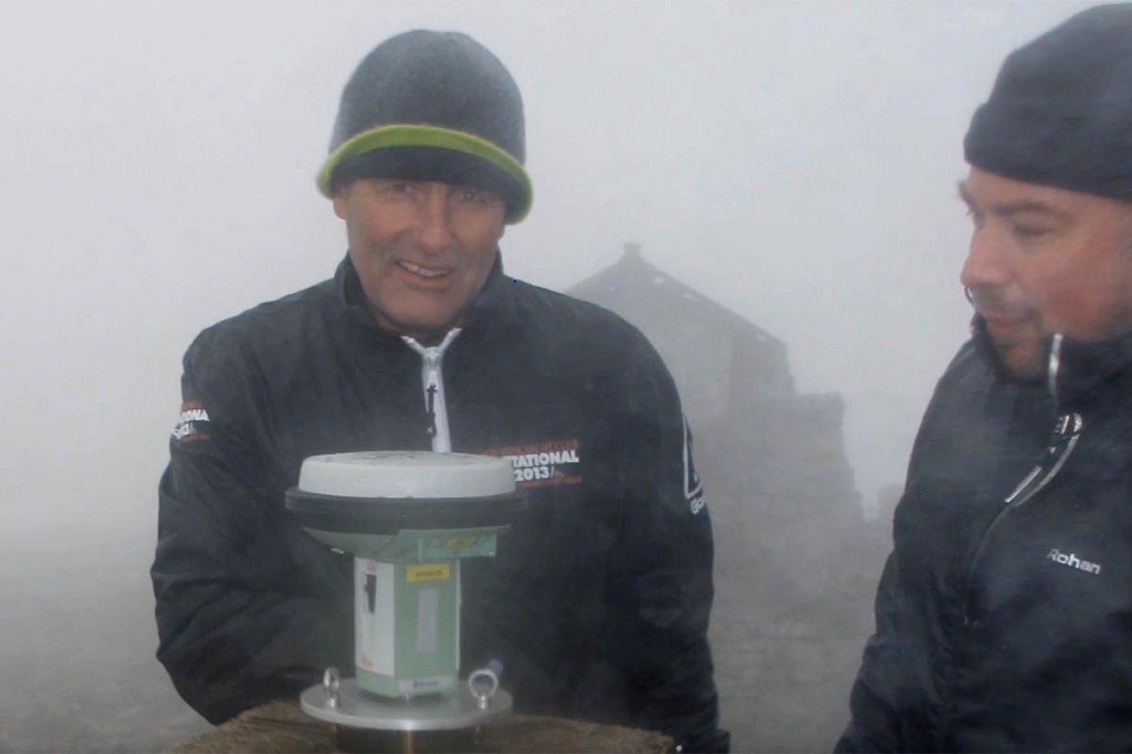 The OS surveyors measure the mountain's height at the trig pillar. Image: Ordnance Survey