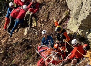 Rescuers at the site with the injured climber. Photo: OVMRO