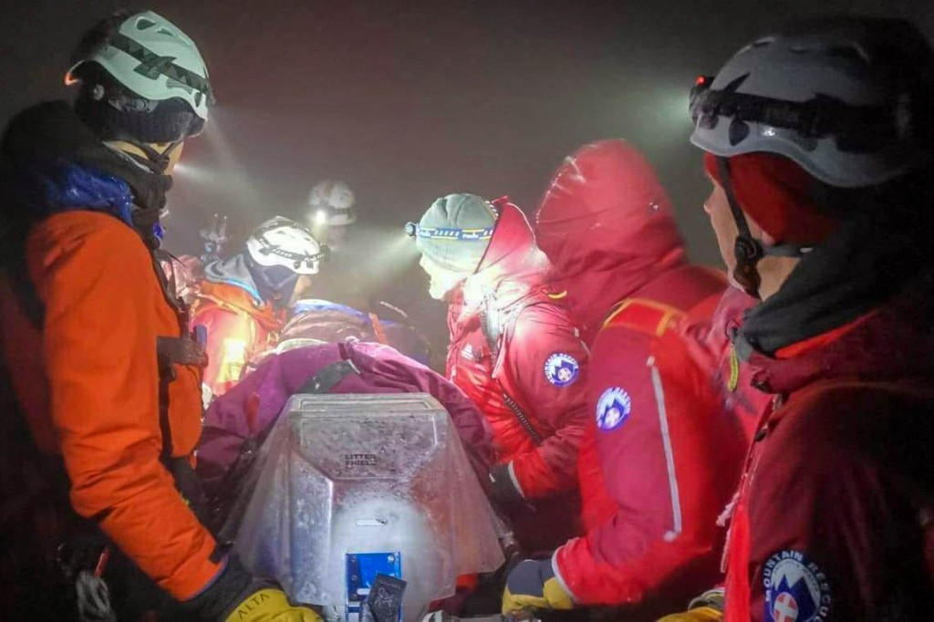 Rescuers with the injured man. Photo: OVMRO