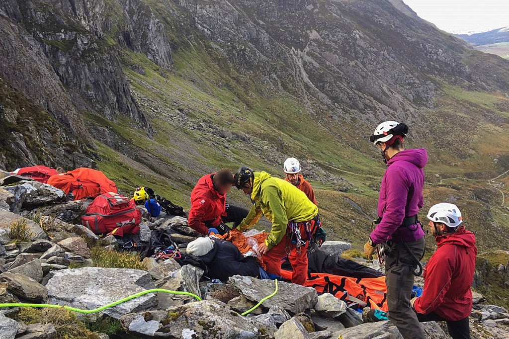 Rescuers with the injured man. Photo: Ogwen Valley MRO Rescuers with the injured man. Photo: Ogwen Valley MRO