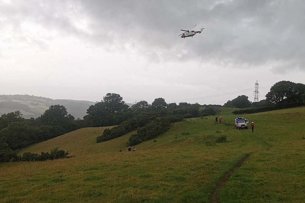 The scene of the incident, with rescue team members and the Coastguard helicopter. Photo: OVMRO