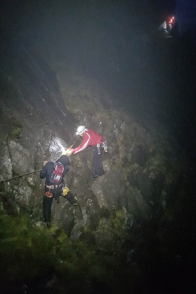 Rescuers help one of the walkers to safety. Photo: Karl Lester/OVMRO Rescuers help one of the walkers to safety. Photo: Karl Lester/OVMRO