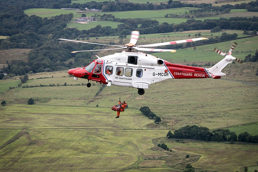 The injured paraglider is winched into the Coastguard helicopter. Photo: Bob Smith/grough