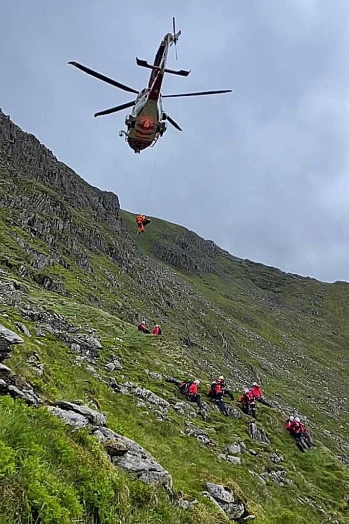 The Coastguard helicopter and rescuers at the scene on Helvellyn. Photo: Patterdale MRT