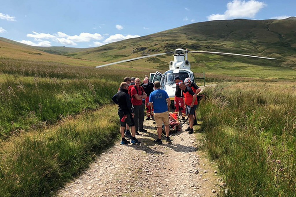 Rescuers with the air ambulance, which landed on the Old Coach Road. Photo: Patterdale MRT Rescuers with the air ambulance, which landed on the Old Coach Road. Photo: Patterdale MRT