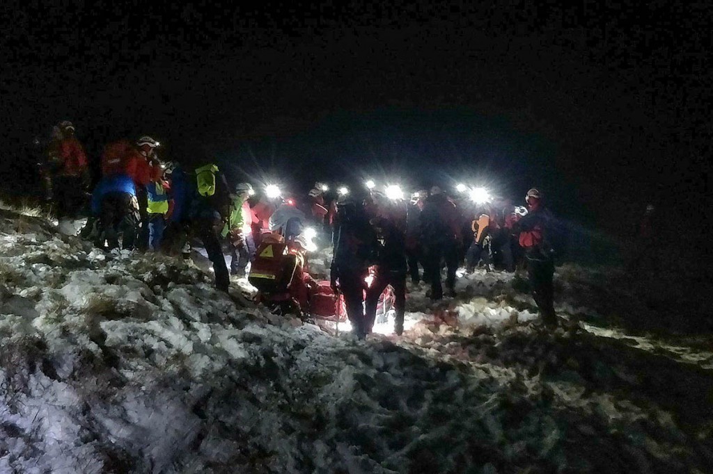 Rescuers lower the injured climber down the mountainside. Photo: Penrith MRT Rescuers lower the injured climber down the mountainside. Photo: Penrith MRT