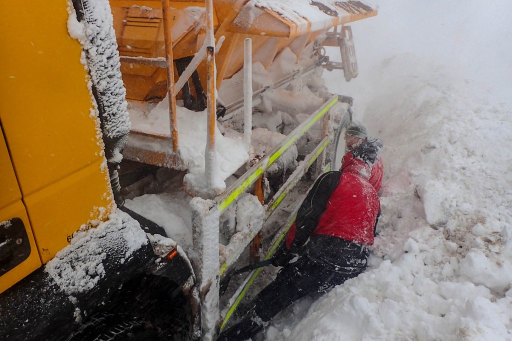 Mountain rescuers work to free the stranded snow plough. Photo: Matt Nightingale
