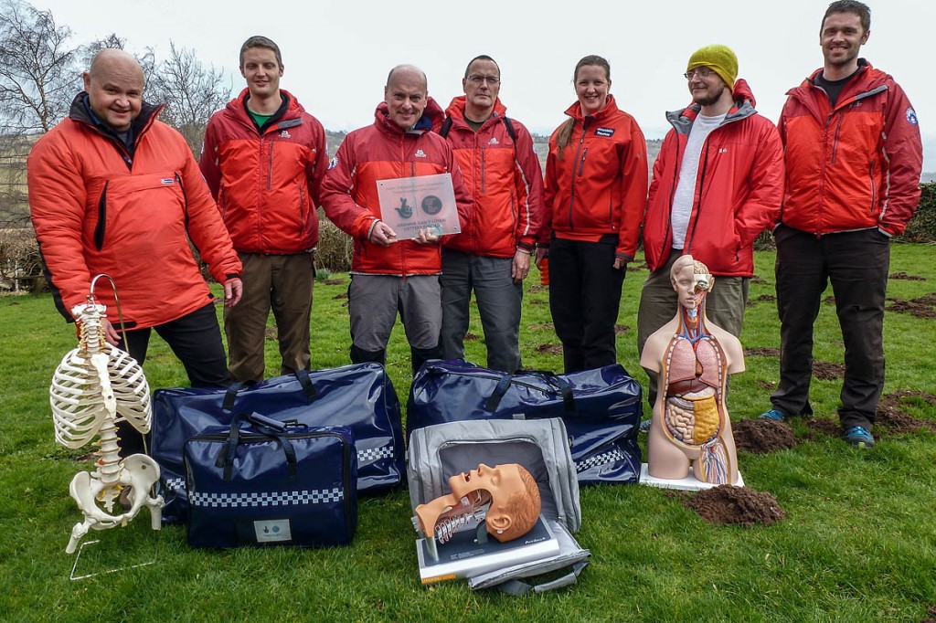 Dr Tim Potts with the association's casualty care instructors and some of the equipment bought with the grant