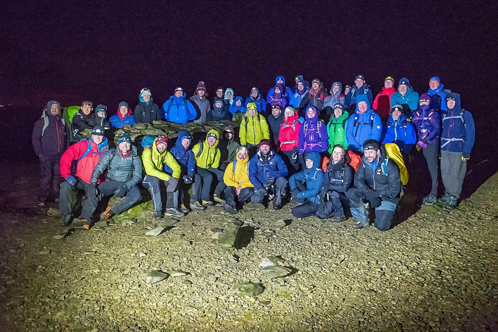 Walkers pose on the summit of the mountain. Photo: Nick Landells/Lakeland Photo Walks