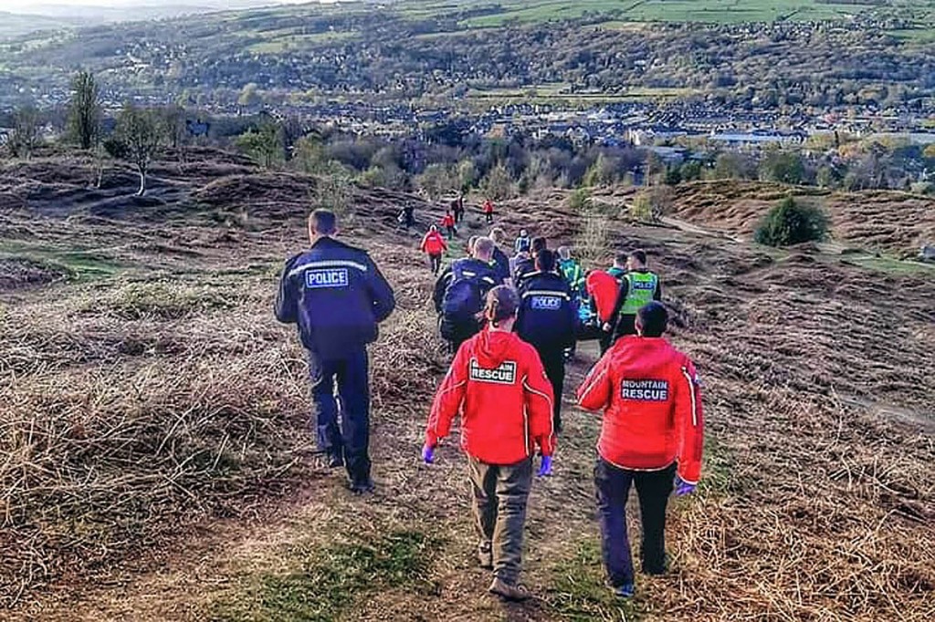 Rescuers help stretcher the injured cyclist from the moor. Photo: UWFRA Rescuers help stretcher the injured cyclist from the moor. Photo: UWFRA