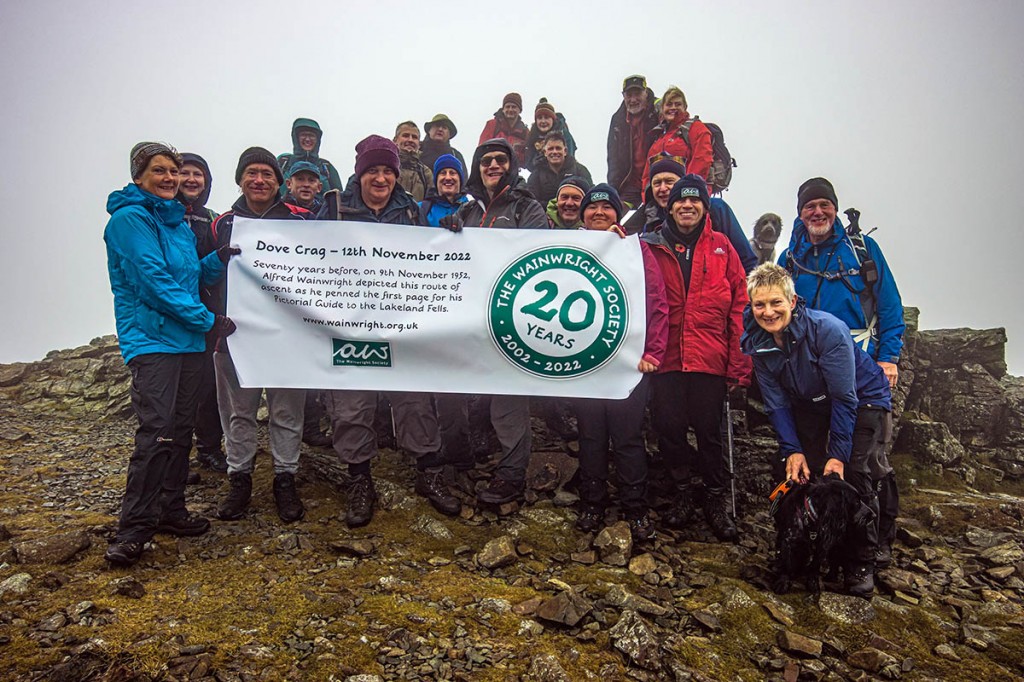 Wainwright Society members celebrate on the summit of Dove Crag. Photo: Ian Nelson