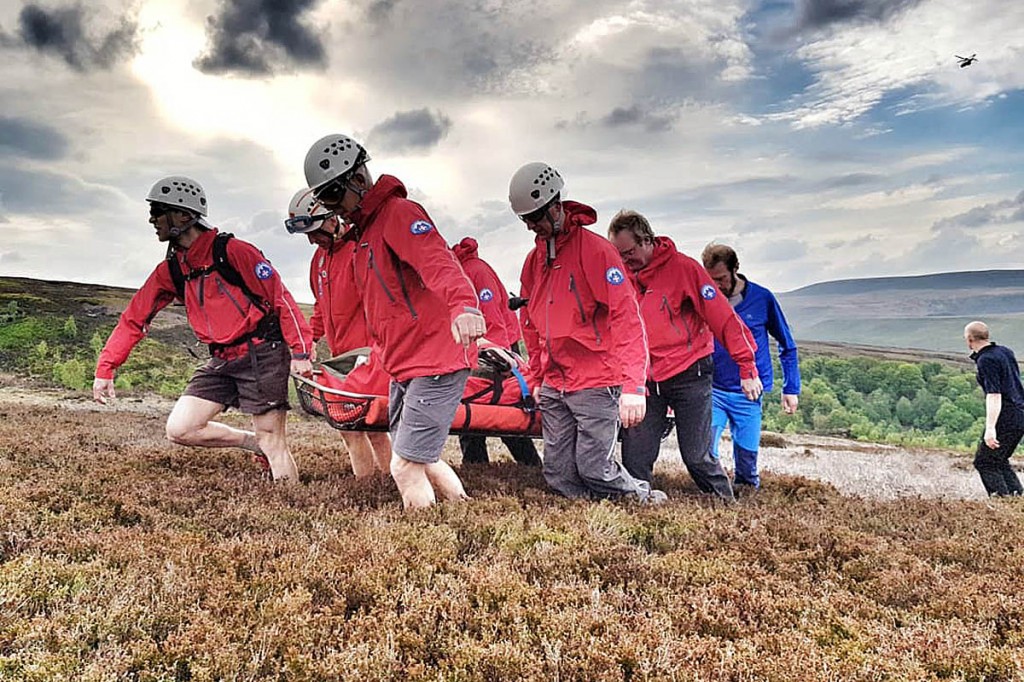 Rescuers stretcher the casualty to the air ambulance. Photo: Woodhead MRT Rescuers stretcher the casualty to the air ambulance. Photo: Woodhead MRT