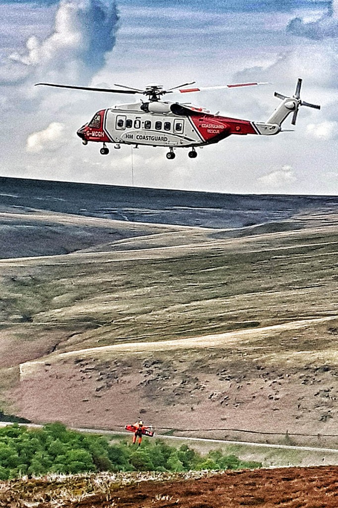 The woman is winched into the Coastguard helicopter. Photo: Woodhead MRT The woman is winched into the Coastguard helicopter. Photo: Woodhead MRT