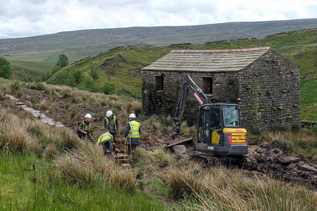 Rangers at work on the route near Ravenseat Farm. Photo: Yorkshire Dales NPA Rangers at work on the route near Ravenseat Farm. Photo: Yorkshire Dales NPA