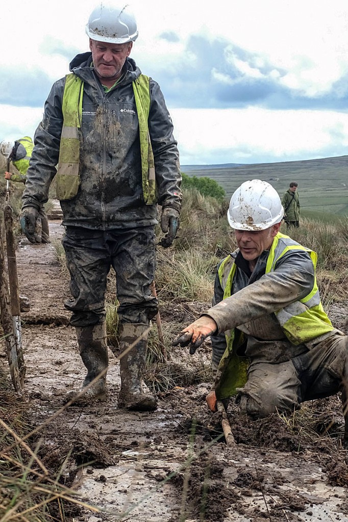 Access rangers Paul Sheehan and Roger Foreman lay flags at the site. Photo: Yorkshire Dales NPA Access rangers Paul Sheehan and Roger Foreman lay flags at the site. Photo: Yorkshire Dales NPA