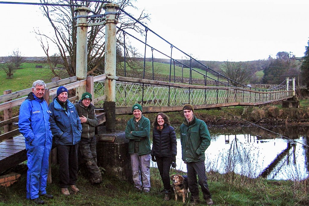 Yorkshire Dales authority staff and Dales Way Association members at the Hebden suspension bridge. Photo: Yorkshire Dales National Park Authority