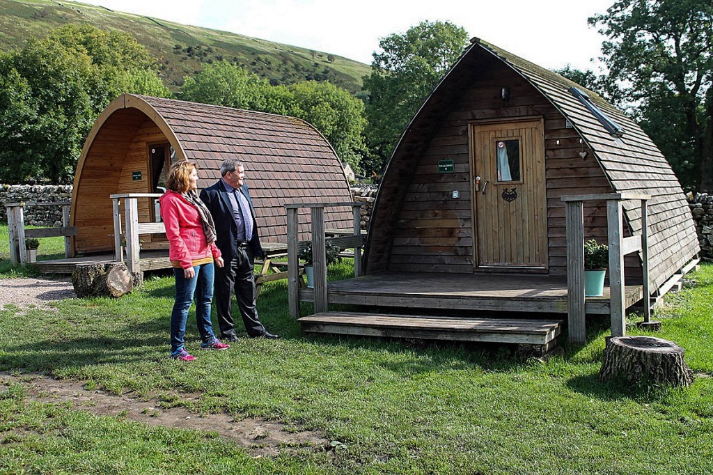 Gill Schofield and Carl Lis look at the camping pods at Heber Farm