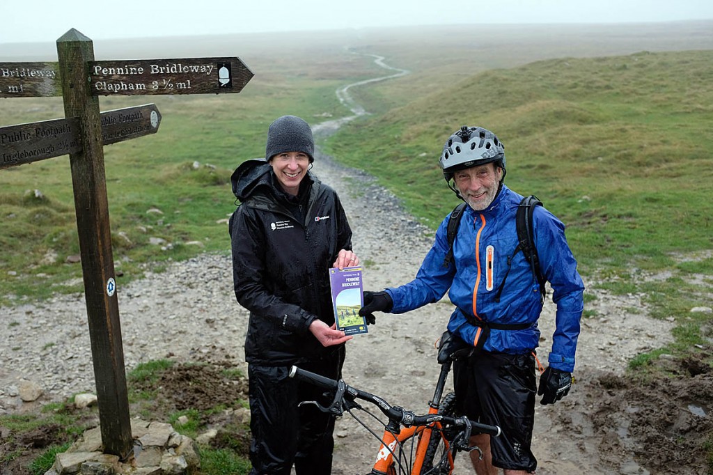 Pennine National Trails Partnership manager Jo McAllister hands the new map to Phil Atherton at Sulber on Ingleborough