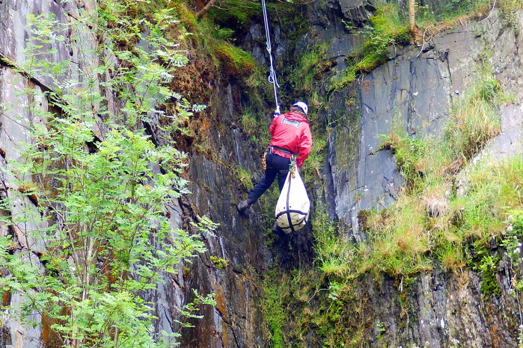 Mac and rescuer Paul Aslin are lowered down to the quarry floor. Photo: Aberdyfi SRT