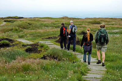 Walkers on Black Hill in the Peak District after a previous restoration project
