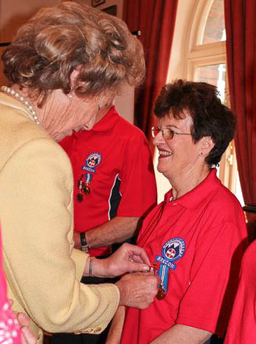 Katie Garnett receives her medal from Lord Lieutenant Shan Legge-Bourke Katie Garnett receives her medal from Lord Lieutenant Shan Legge-Bourke