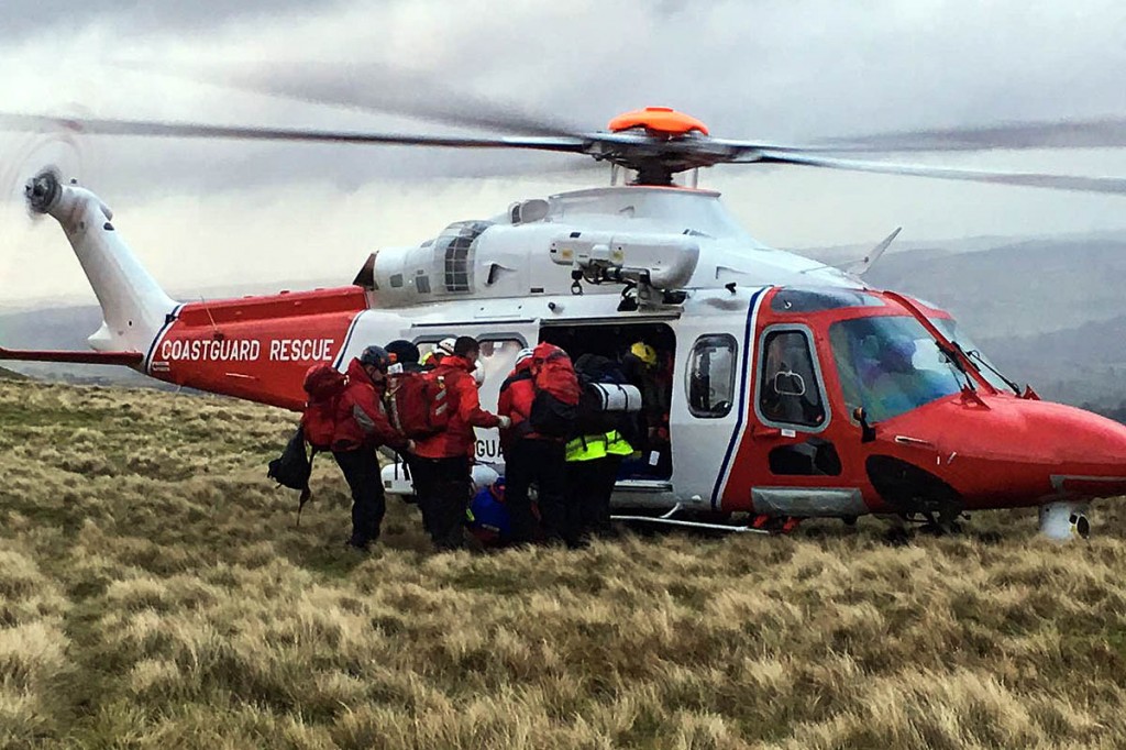 Brecon MRT members with the St Athan Coastguard helicopter during the 100th rescue. Photo: Brecon MRT