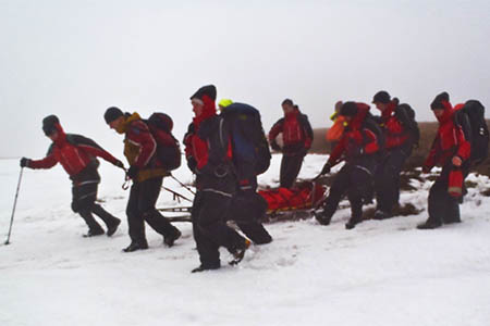 Rescuers sledge the ill teenager from the summit of Waun Fach. Photo: Brecon MRT Rescuers sledge the ill teenager from the summit of Waun Fach. Photo: Brecon MRT