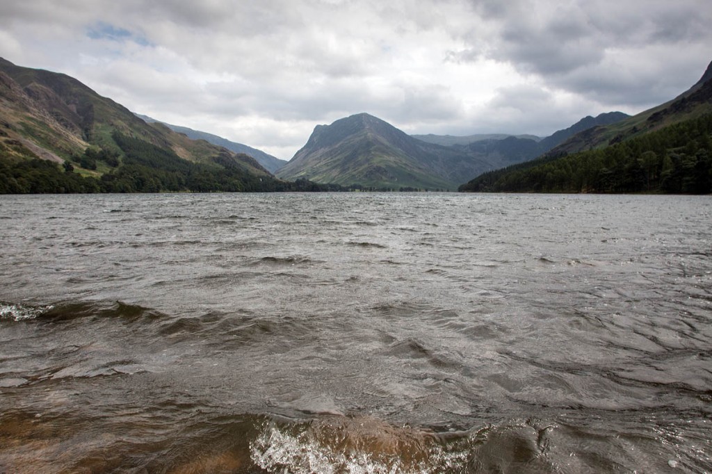 The woman was walking on the Buttermere shore path The woman was walking on the Buttermere shore path